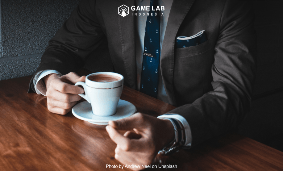 "man holding cup filled with coffee on table" Photo by Andrew Neel on Unsplash