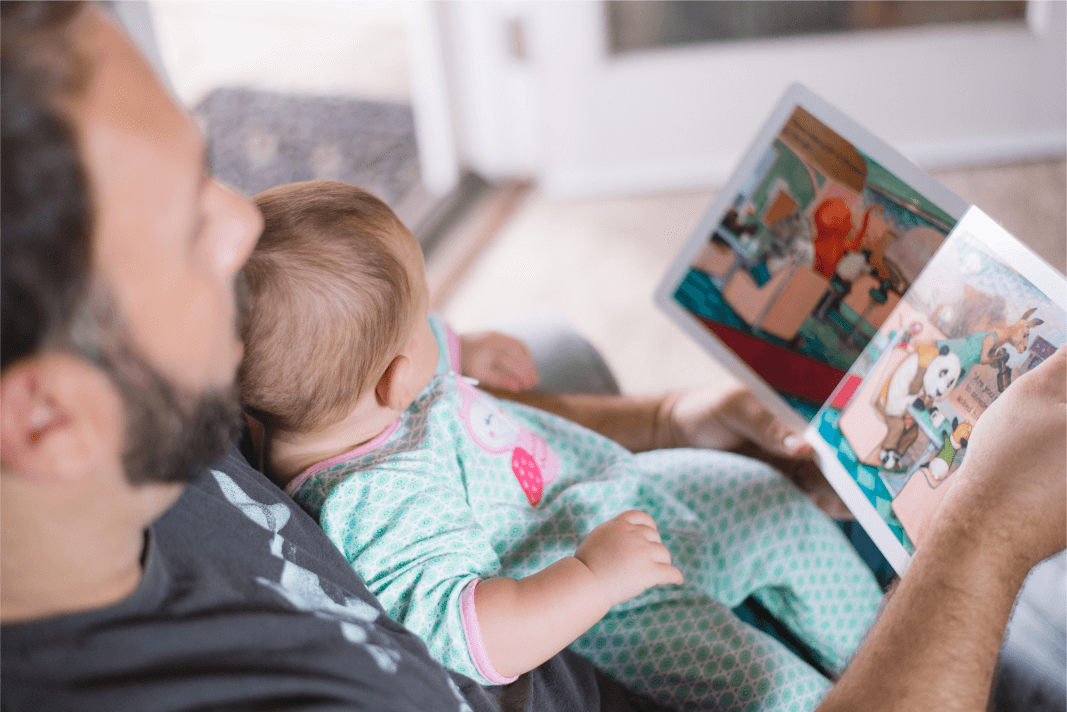 "person carrying baby while reading book" Photo by Picsea on Unsplash